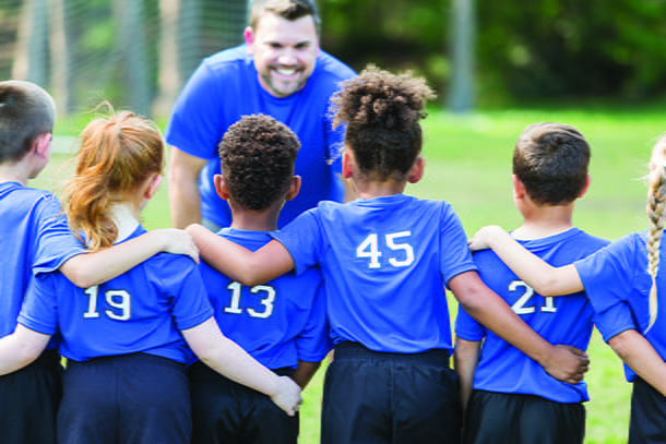 coach talking to youth team