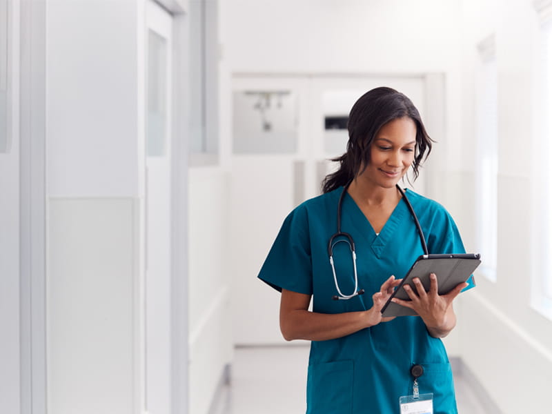 Top image Nurse holding tablet min image
